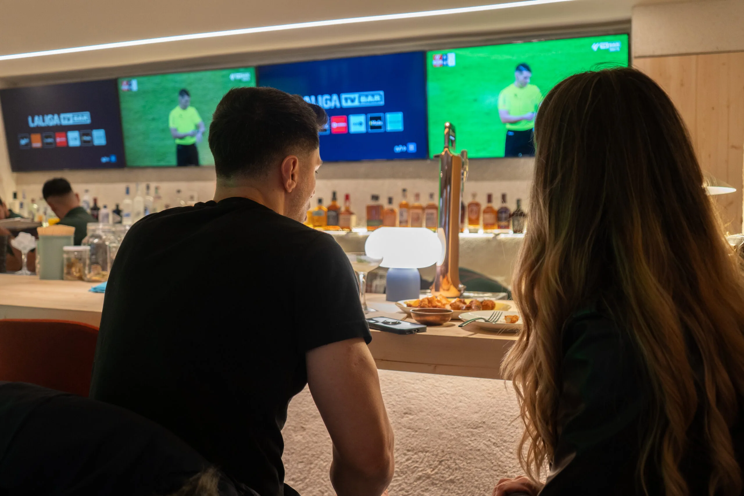 The Miami Club lounge — booths, low tables, ambient light